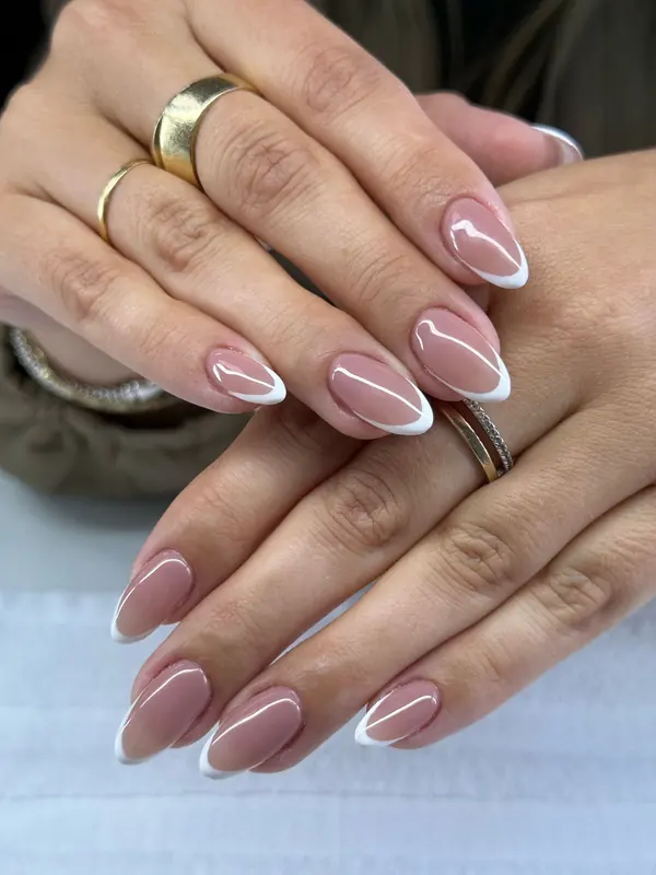Manicure detail with a delicate ring and neutral polish