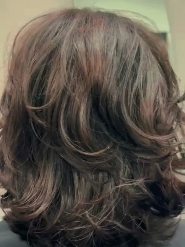 Long curled hair styled at the salon