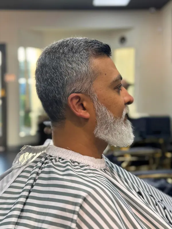 Barber shaping a short men’s haircut at Bliss & Blade