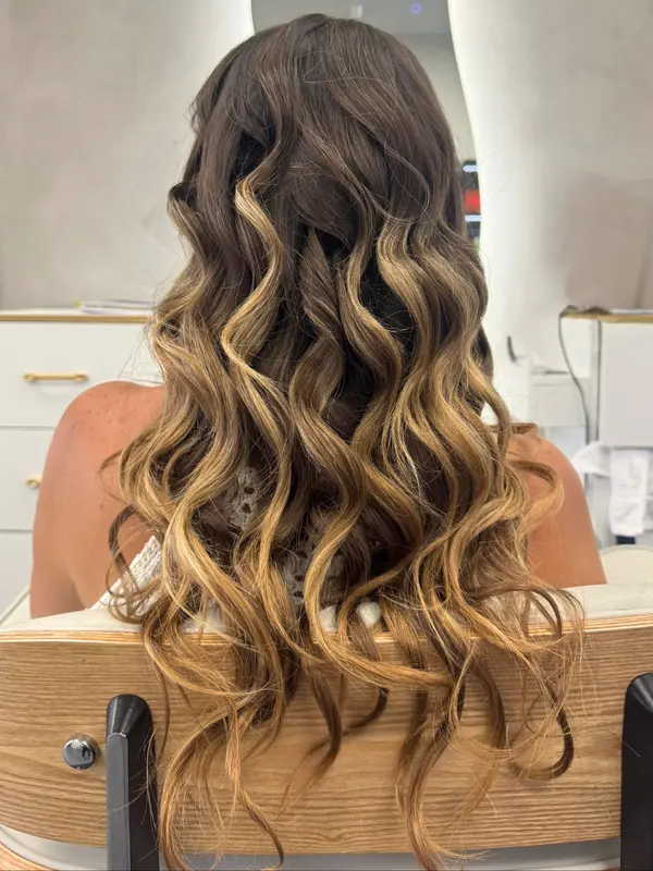 Long brunette hair styled in defined curls