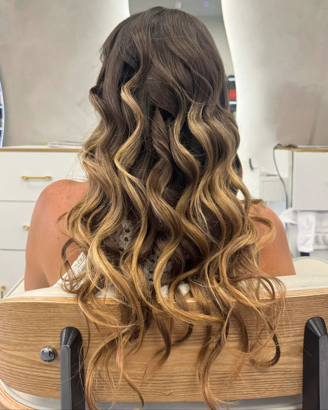 Long wavy hair with dark roots and lighter lengths