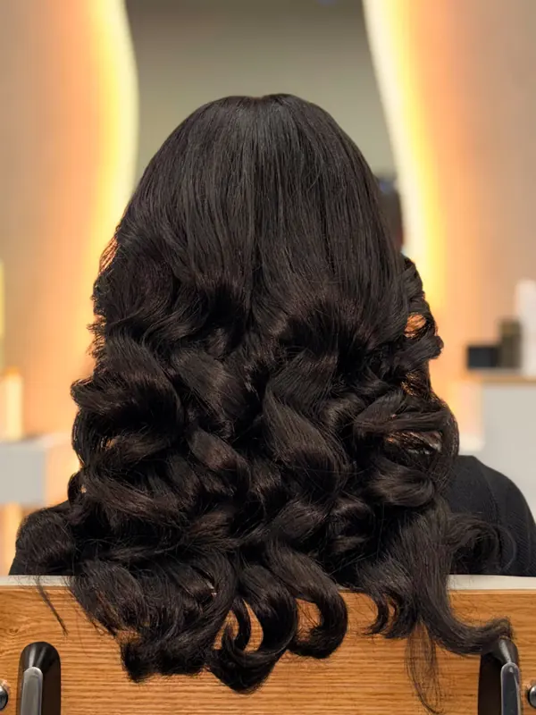 Elegant brunette updo styled at Bliss & Blade