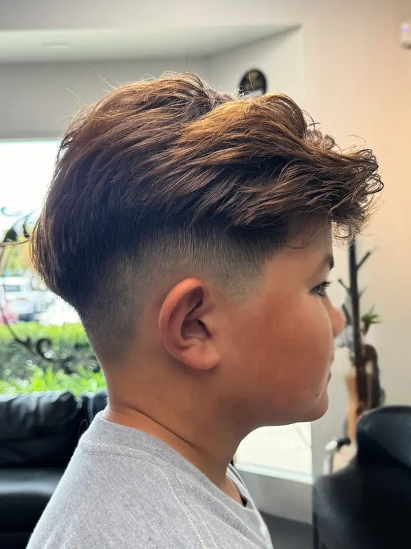 Men’s haircut with a textured top and faded sides
